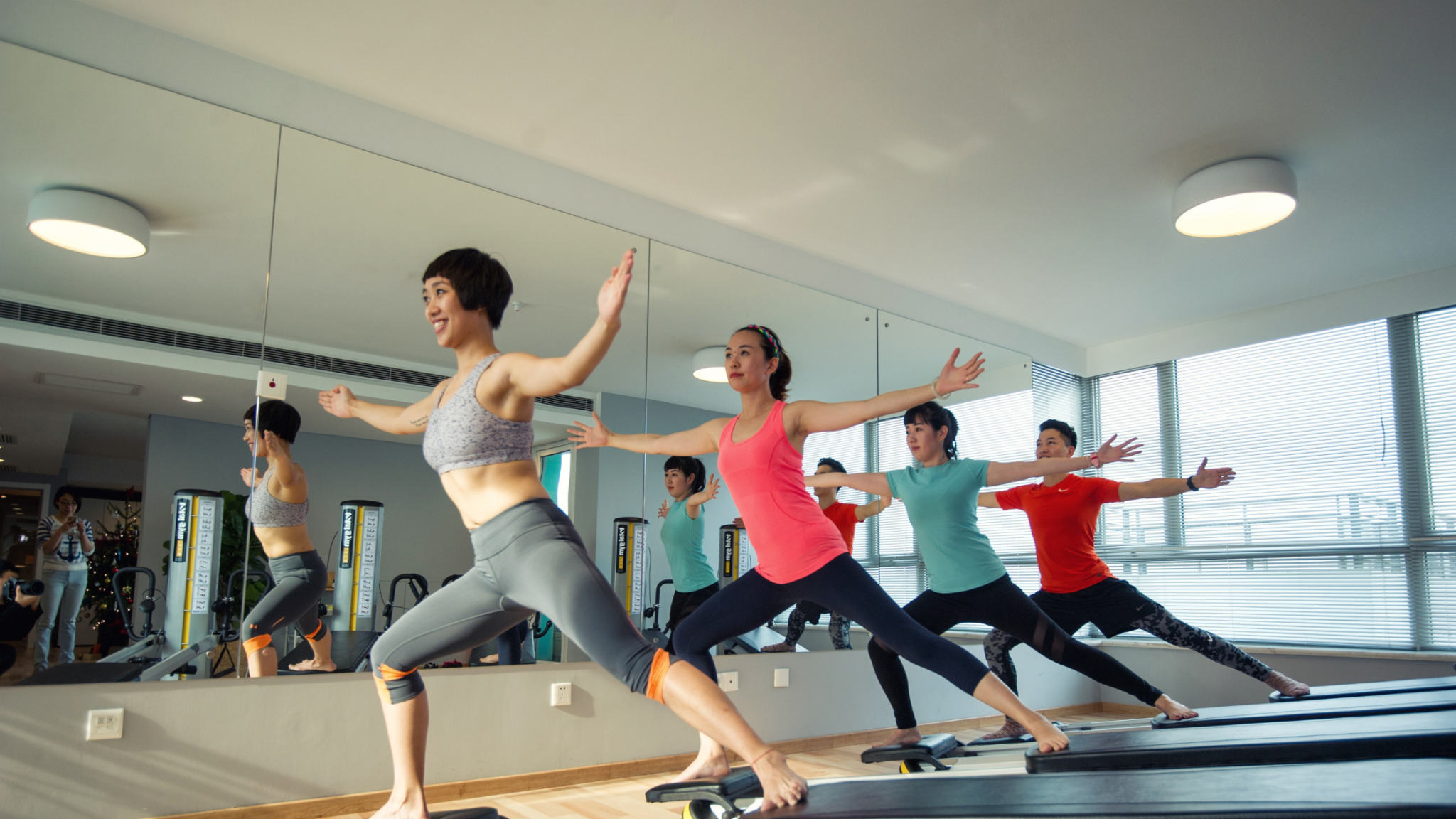 studio members doing reformer pilates class
